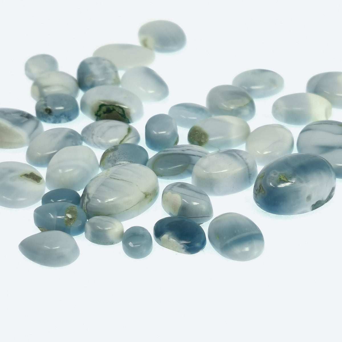 Denim blue opal cabochon from Oregon – scattered cabochons