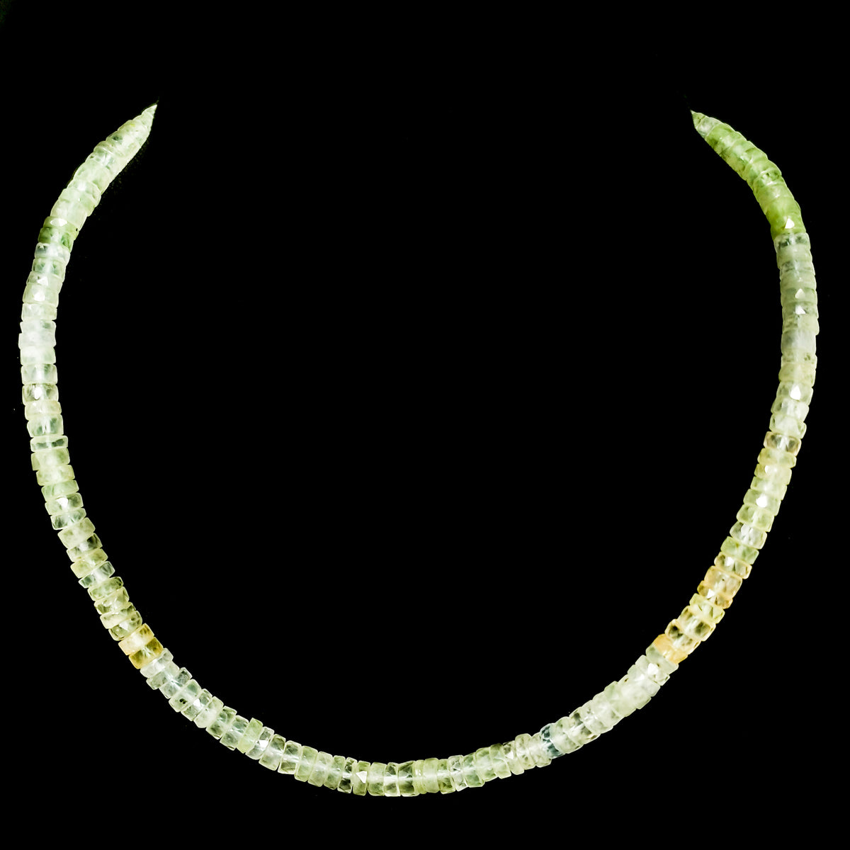 Wheel Shape facet bead necklace in sterling silver and steel wire.