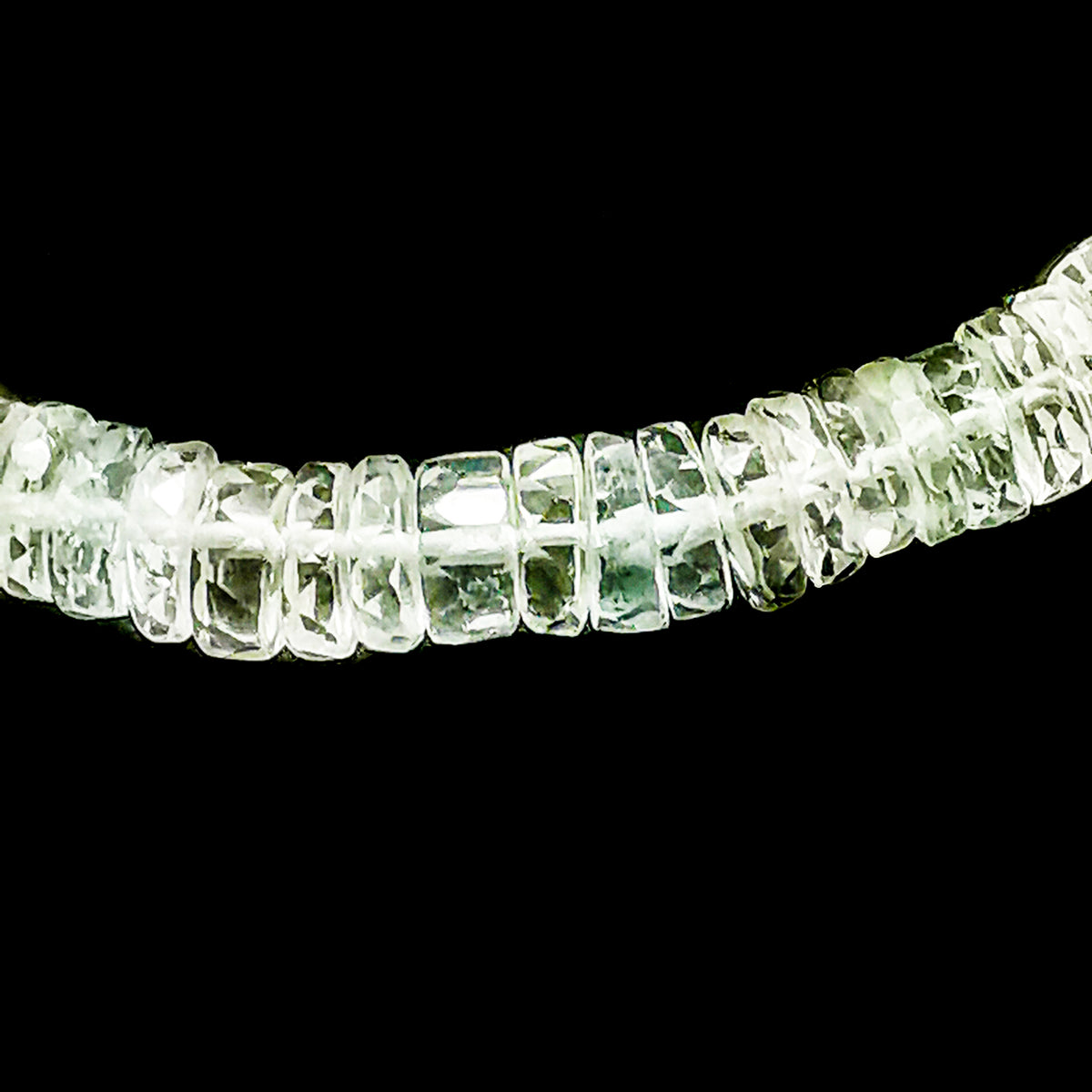 Wheel Shape facet bead necklace in sterling silver and steel wire.