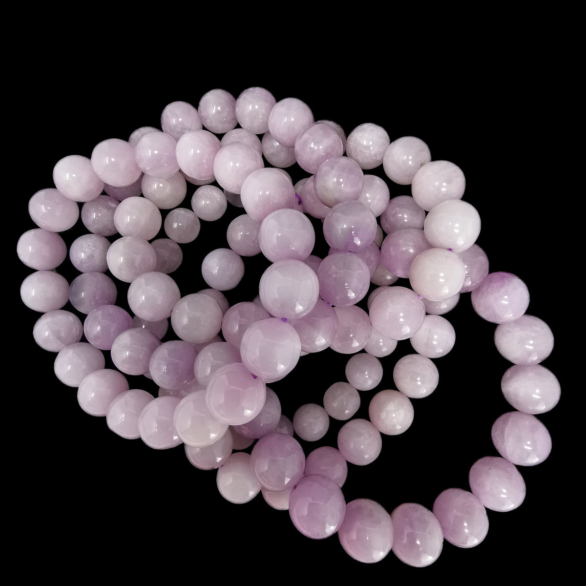 Kunzite bead bracelet from Pakistan – pile of bracelets