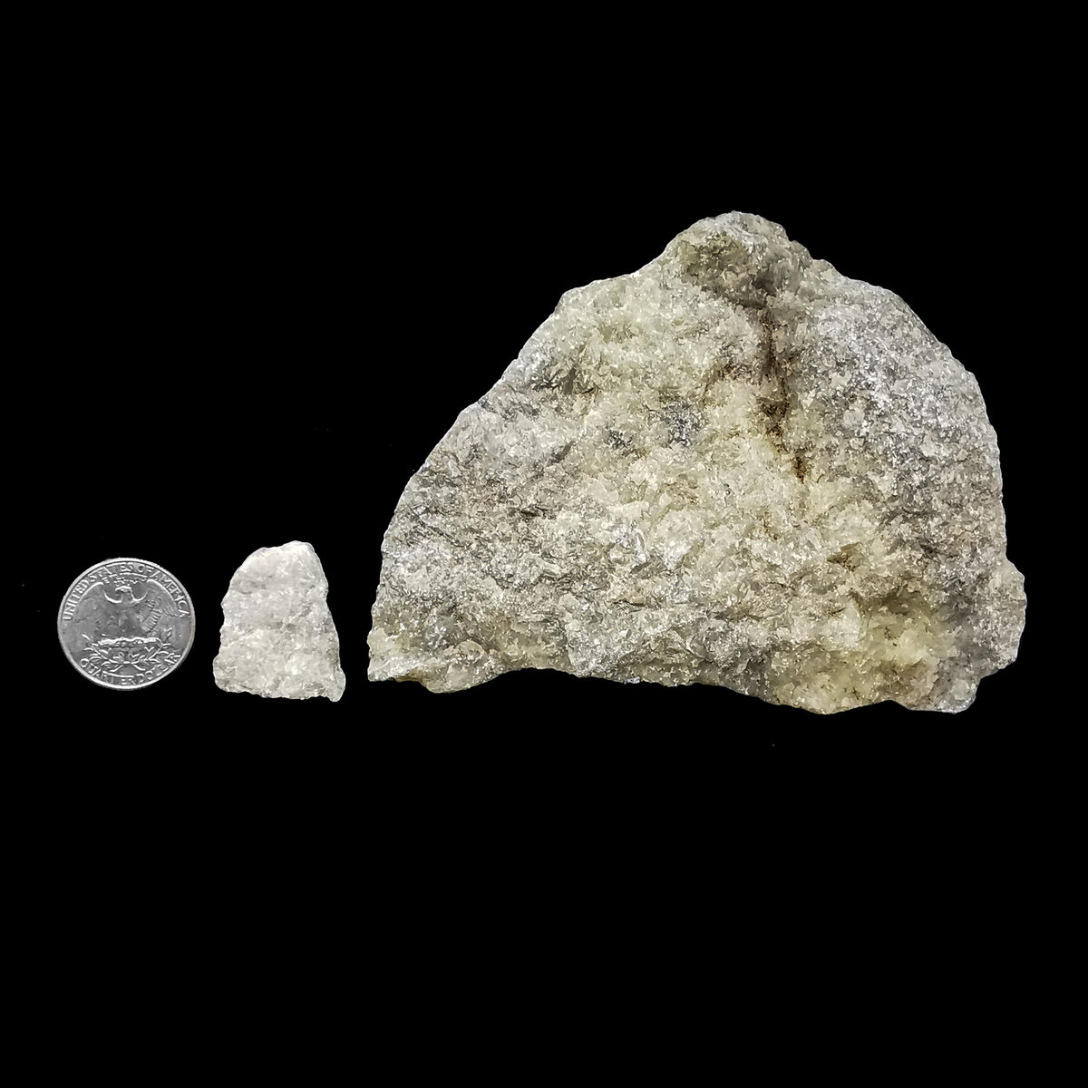 Marble rough: two pieces beside a coin for scale