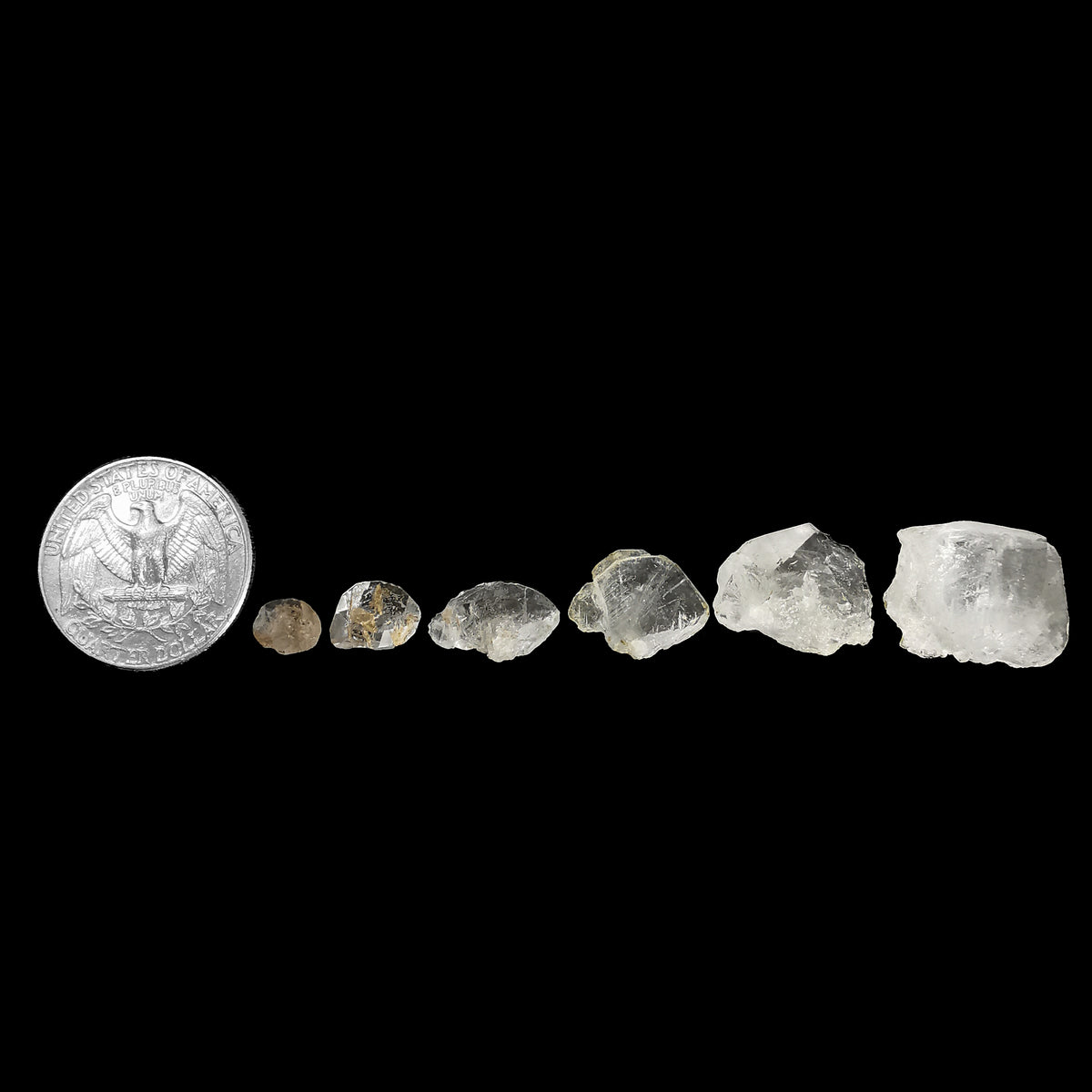 Phenakite crystal from Zhytomyr Oblast, Ukraine – crystals by size beside a coin for scale