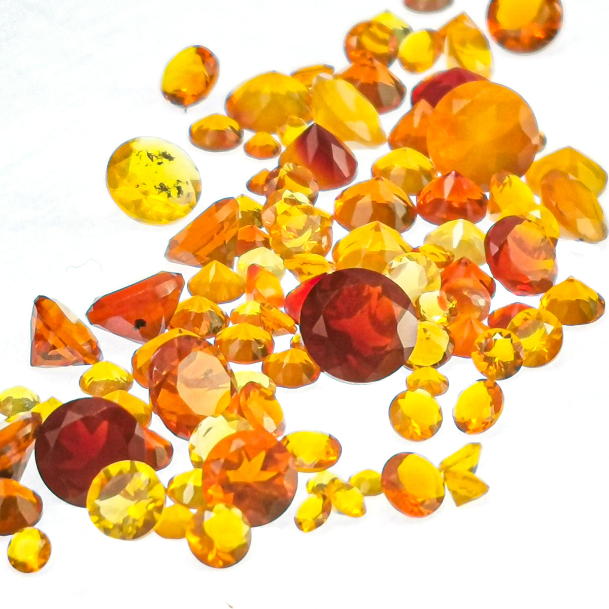Fire Opal round facet, hydrated silica, from Juniper Ridge, Oregon, USA.