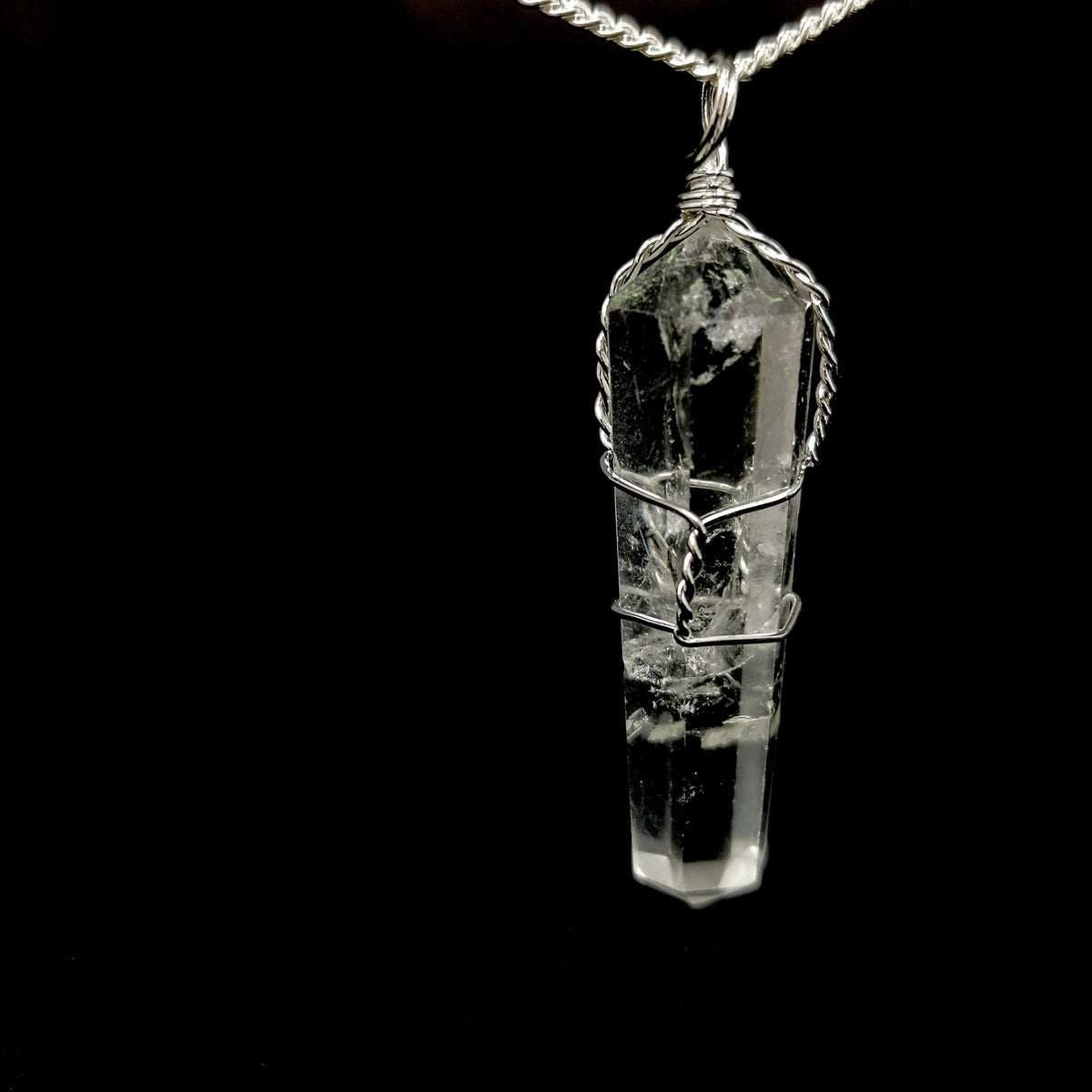 Wire wrap crystal pendant – clear quartz, dark background