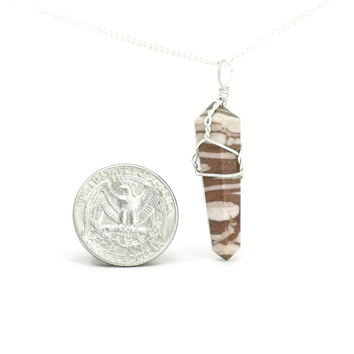 Wire wrap crystal pendant – pendant beside a coin for scale